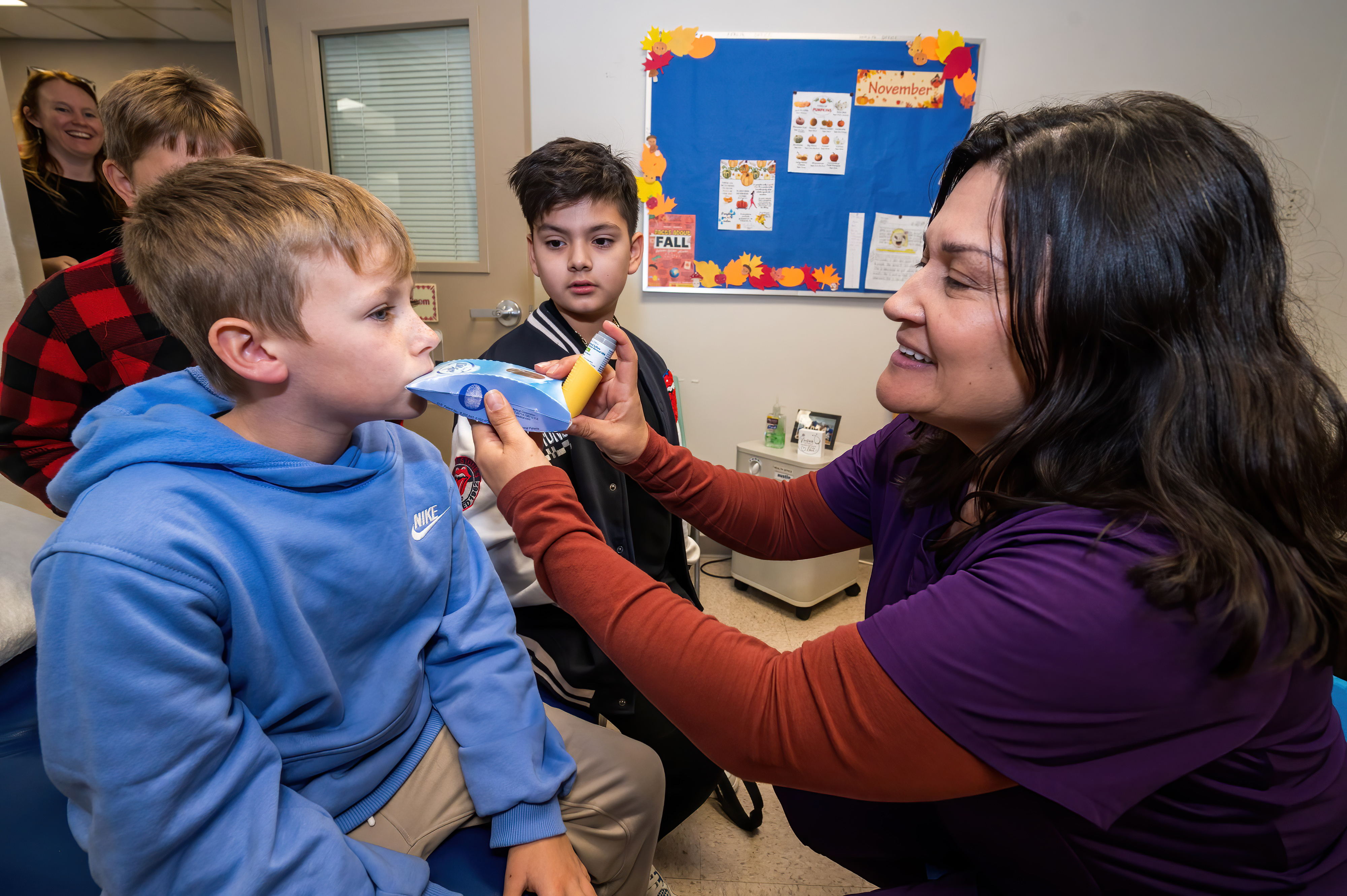 Photo of school health staff administering a stock inhaler to a student